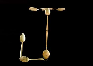 Letter J made of spoons