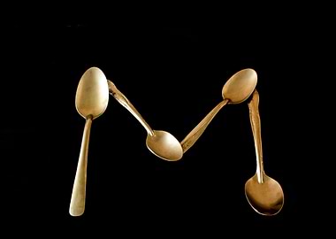Letter M made of spoons
