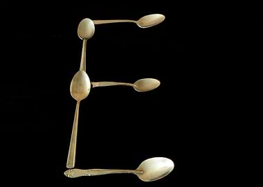 Letter E made of spoons