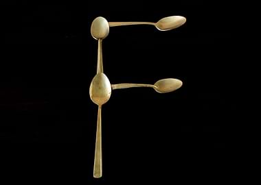 Letter F made of spoons