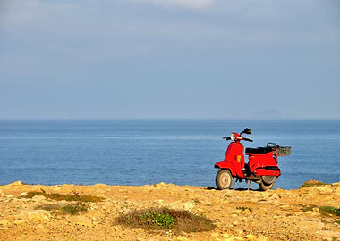 Red motorscooter in nature