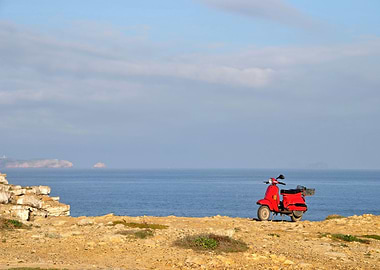 Red motorscooter in nature