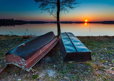 Boats On Lake Shore At Sun