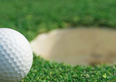 golf ball on lip of cup