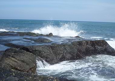 Waves crash into sea rocks