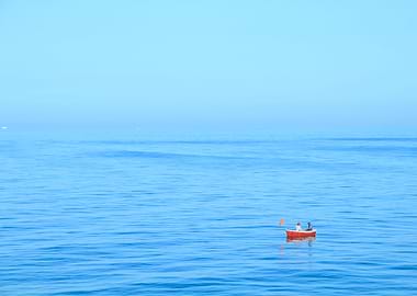 Red boat in a blue sea