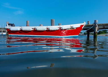 Docked rowboat reflects