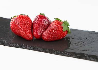 Three strawberries on slat