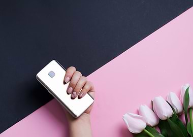 hand with phone and tulips