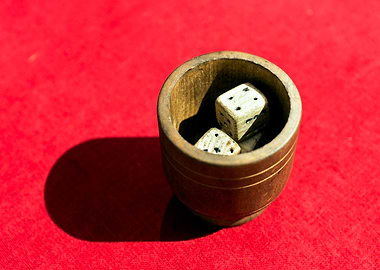 Bowl Of Dices On Red Table