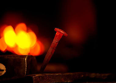 Hot metal nail on anvil
