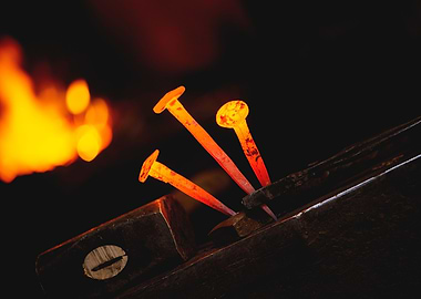 Hot metal nail on anvil