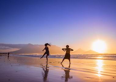Women dancing on beach