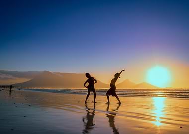 Women dancing on beach