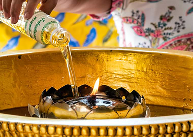 Woman lighting an oil cand