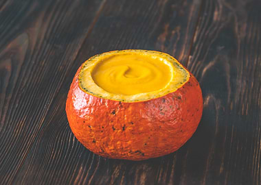 Pumpkin soup served inside