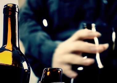 NM Drunk man bottles wine