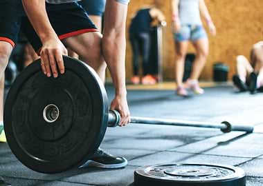 Man Holding Black Barbell