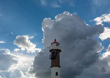 A lighthouse with clouds