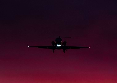 Private Jet on sunset sky