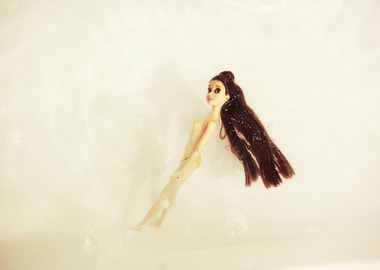Doll floating in water
