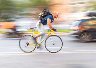 Man riding yellow bicycle