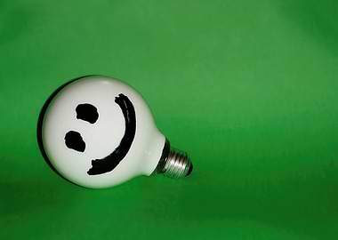 White smiling bulb on gree
