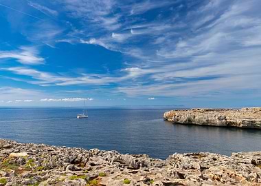 White sailboat in blue sea