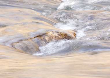 Water flowing over a rock