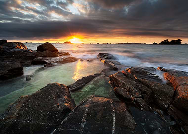 rocky shore under cloudy