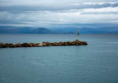 Coastal Lighthouse with Mountains