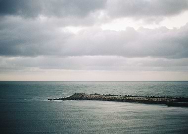 Seawall Under Cloudy Sky