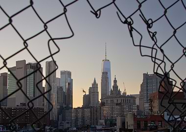 NYC Skyline Through Fence of Manhattan Bridge at sunset