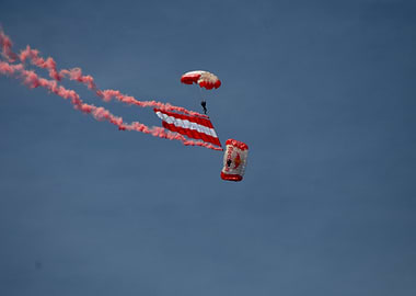 Skydivers with Red Bull Parachute and Austria Flag