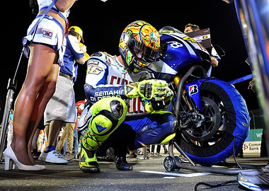 MotoGP Racer Kneeling by Bike