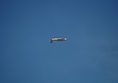 Plane in Blue Sky flying upside down