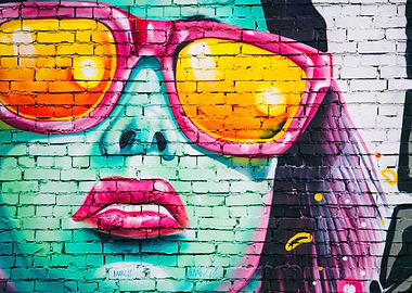 brick wall with woman's face mural graffiti