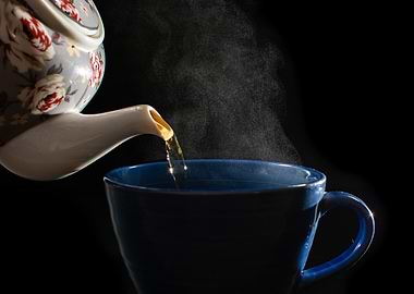 Pouring Tea into Blue Cup
