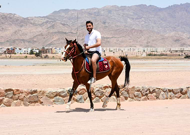 Man Riding Horse in Desert