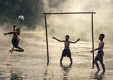 Boys Playing Soccer in Water