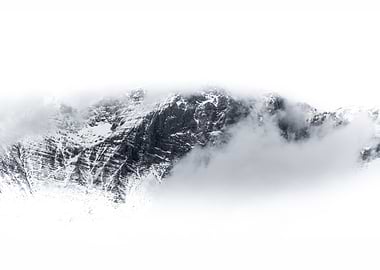 Snowy Mountain surrounded by clouds and fog