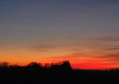 Crimson Sunset with Crescent Moon