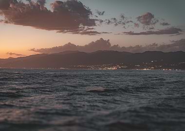 Coastal Sunset with City Lights