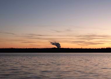 Sunset Over Lake with Smoke Plume