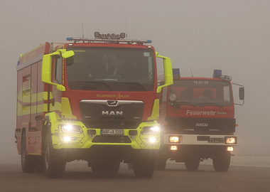 Two Fire Trucks in Fog