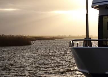 Boat on Calm Water at Sunset