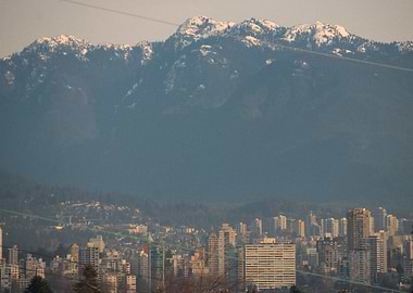 Cityscape with Snowy Mountains