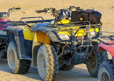 Yellow ATV on Sandy Terrain