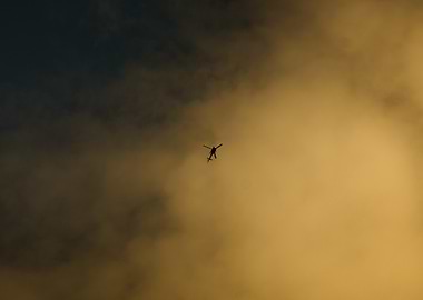 Helicopter in Cloudy Sky