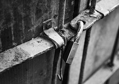 Rusty Padlock on Metal Gate